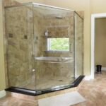 A bathroom with a glass shower stall and toilet, perfect for a bathroom remodel.