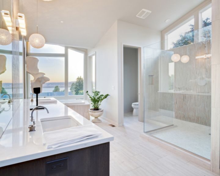 A modern bathroom with a clear glass shower stall.