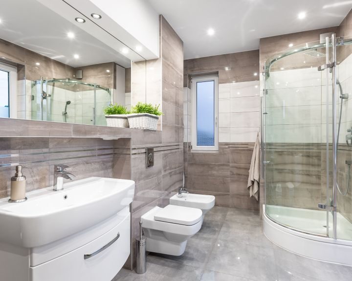 A modern bathroom with a glass shower stall and sink, perfect for a sleek bathroom design.