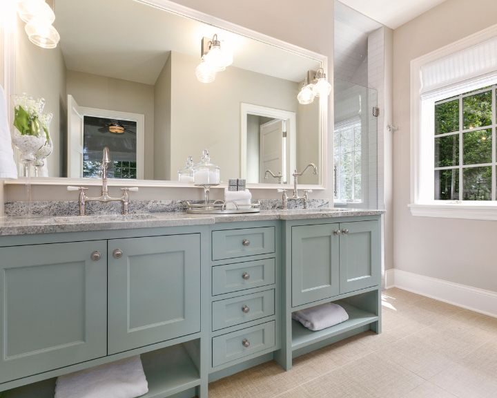 A New Haven-themed bathroom featuring two sinks and stylish cabinets.