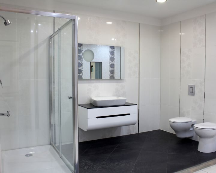 A white bathroom designs with a City-inspired design featuring a shower stall and toilet.