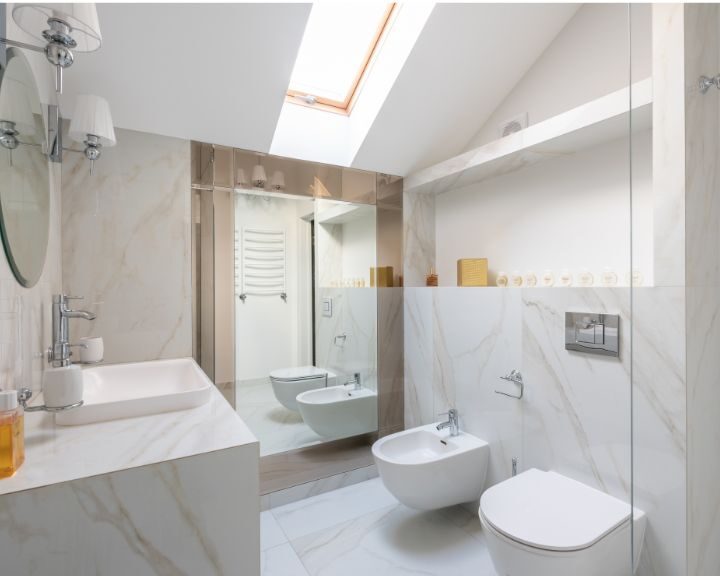 A modern bathroom design featuring a skylight and marble floors.