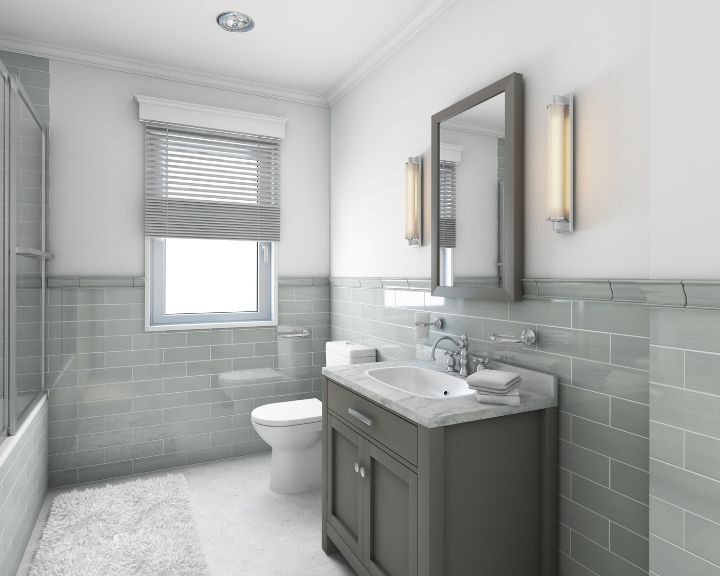 A New Haven bathroom with grey tiled walls and a white toilet.