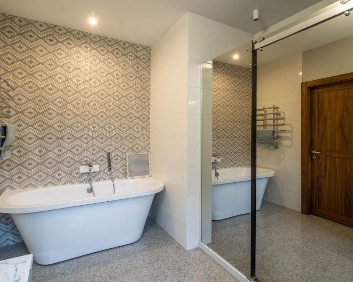 A bathroom with a bathtub and shower.