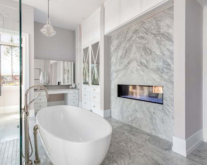 A white bathroom with a luxurious marble bathtub in the city.
