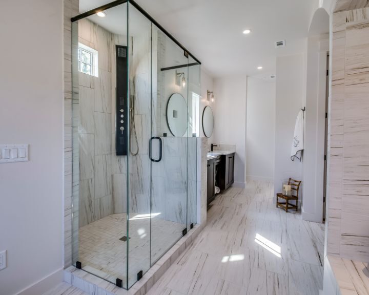 A white bathroom with a glass shower.